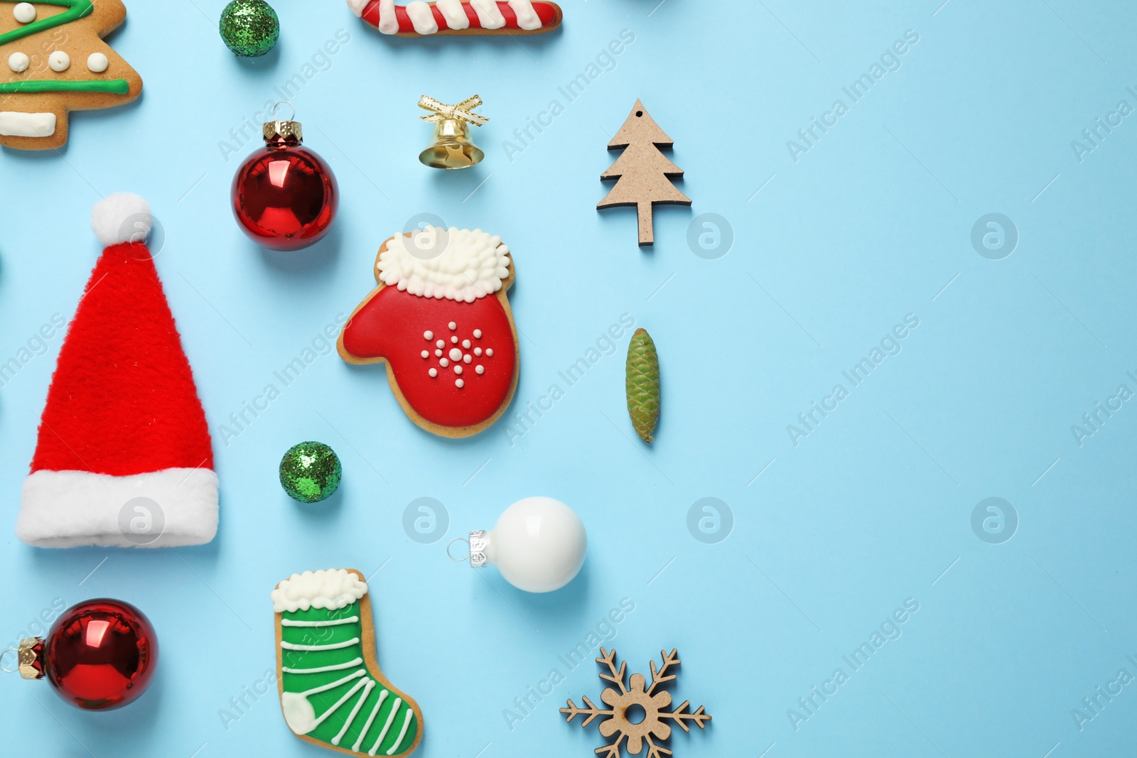 Photo of Flat lay composition with Christmas decorations on light blue background