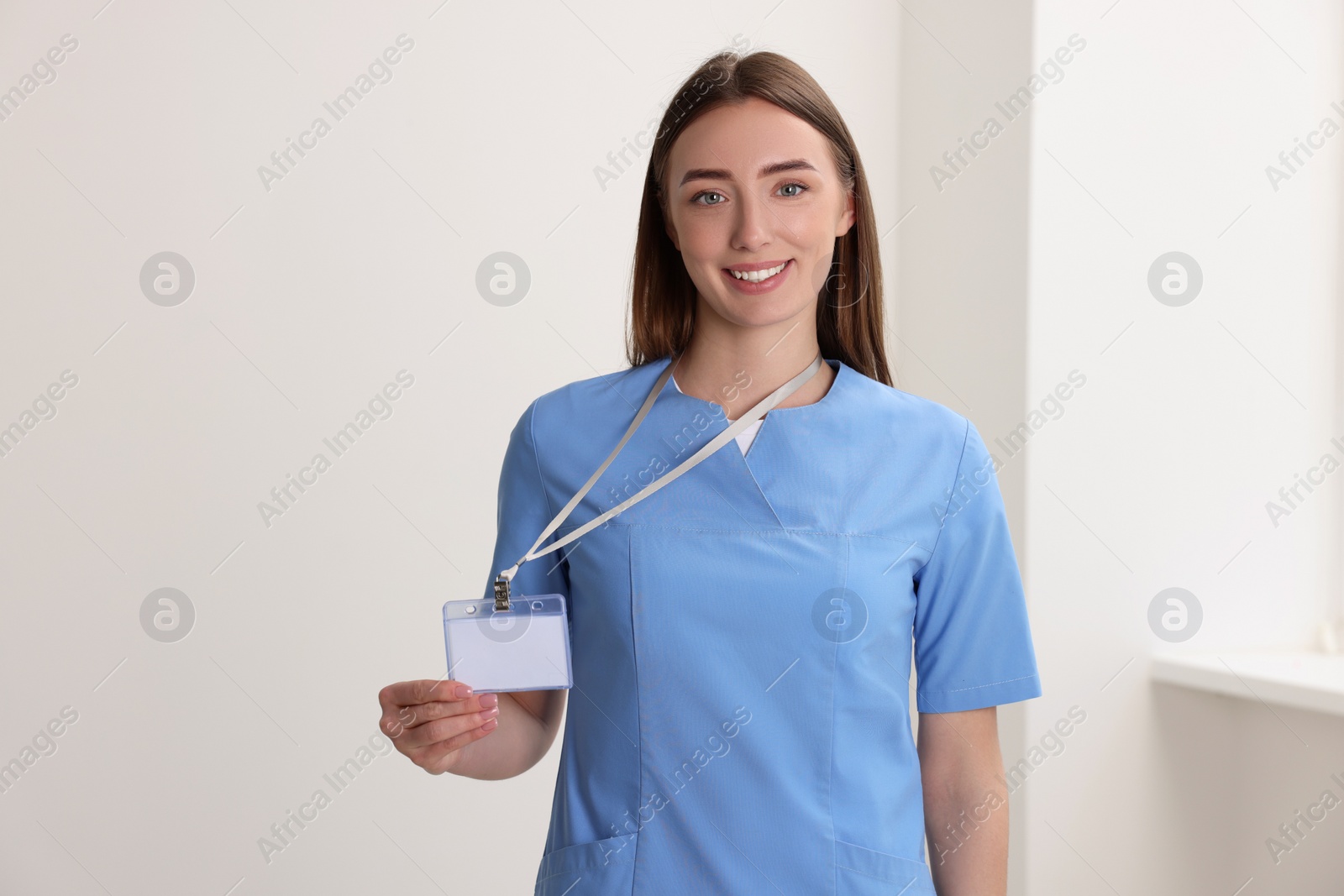 Photo of Happy doctor with blank badge in hospital