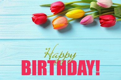 Image of Happy Birthday! Beautiful tulips on blue wooden background, top view