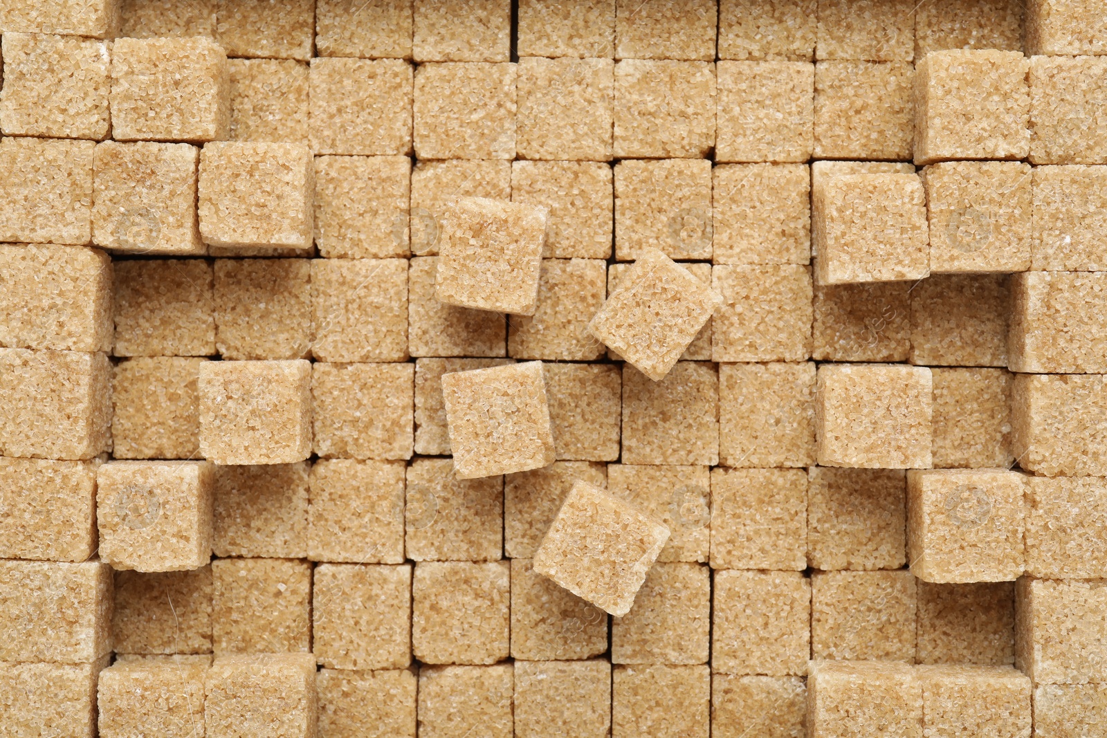 Photo of Brown sugar cubes as background, top view