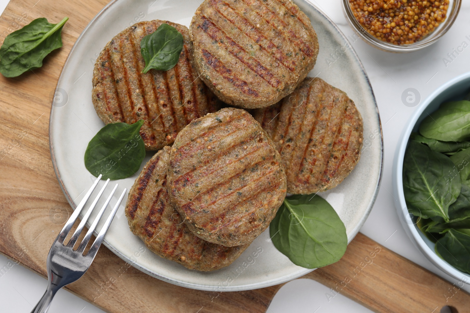 Photo of Tasty grilled vegan cutlets served on white table, flat lay