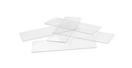 Pile of clean glass microscope slides on white background