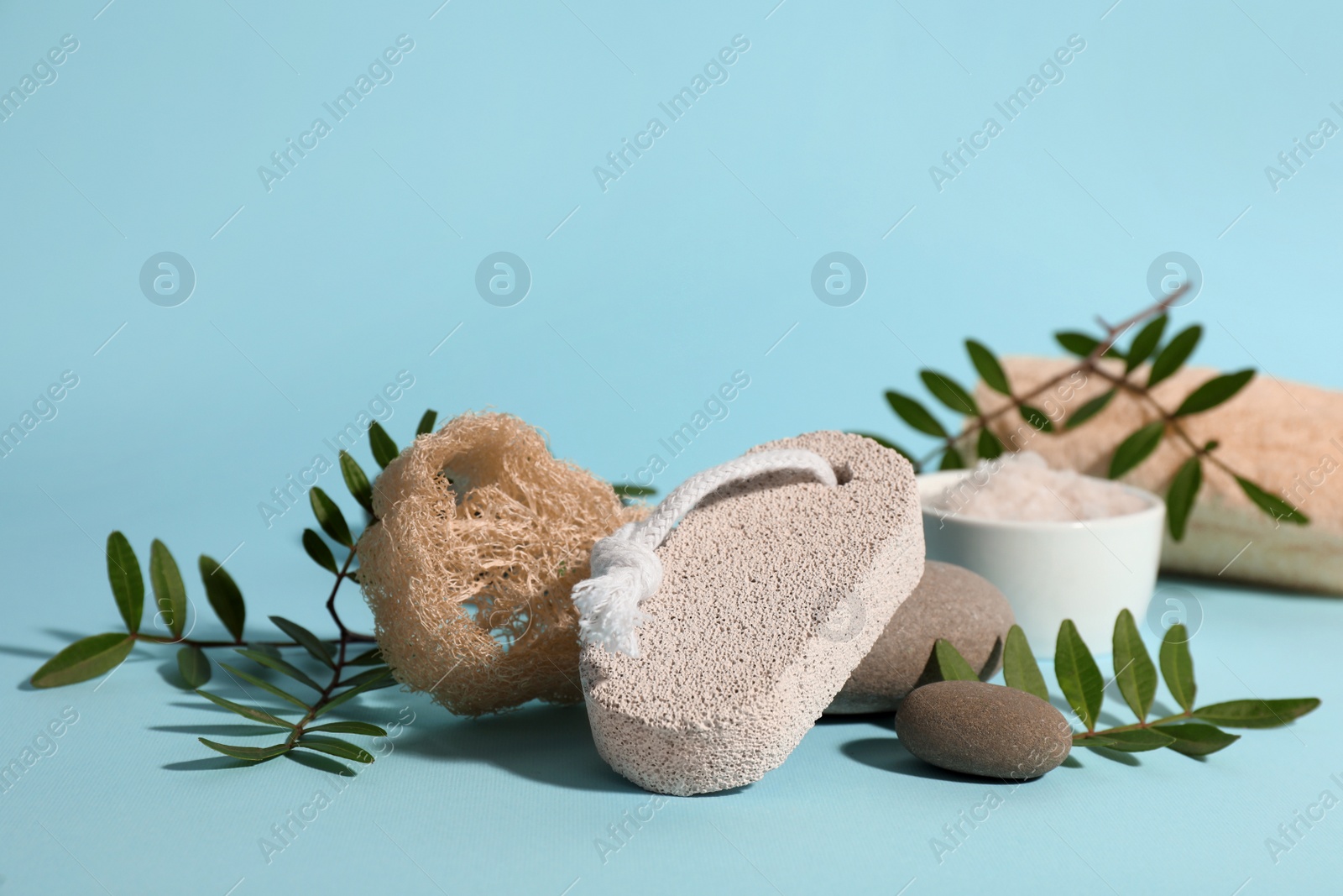 Photo of Composition with pumice stone on light blue background