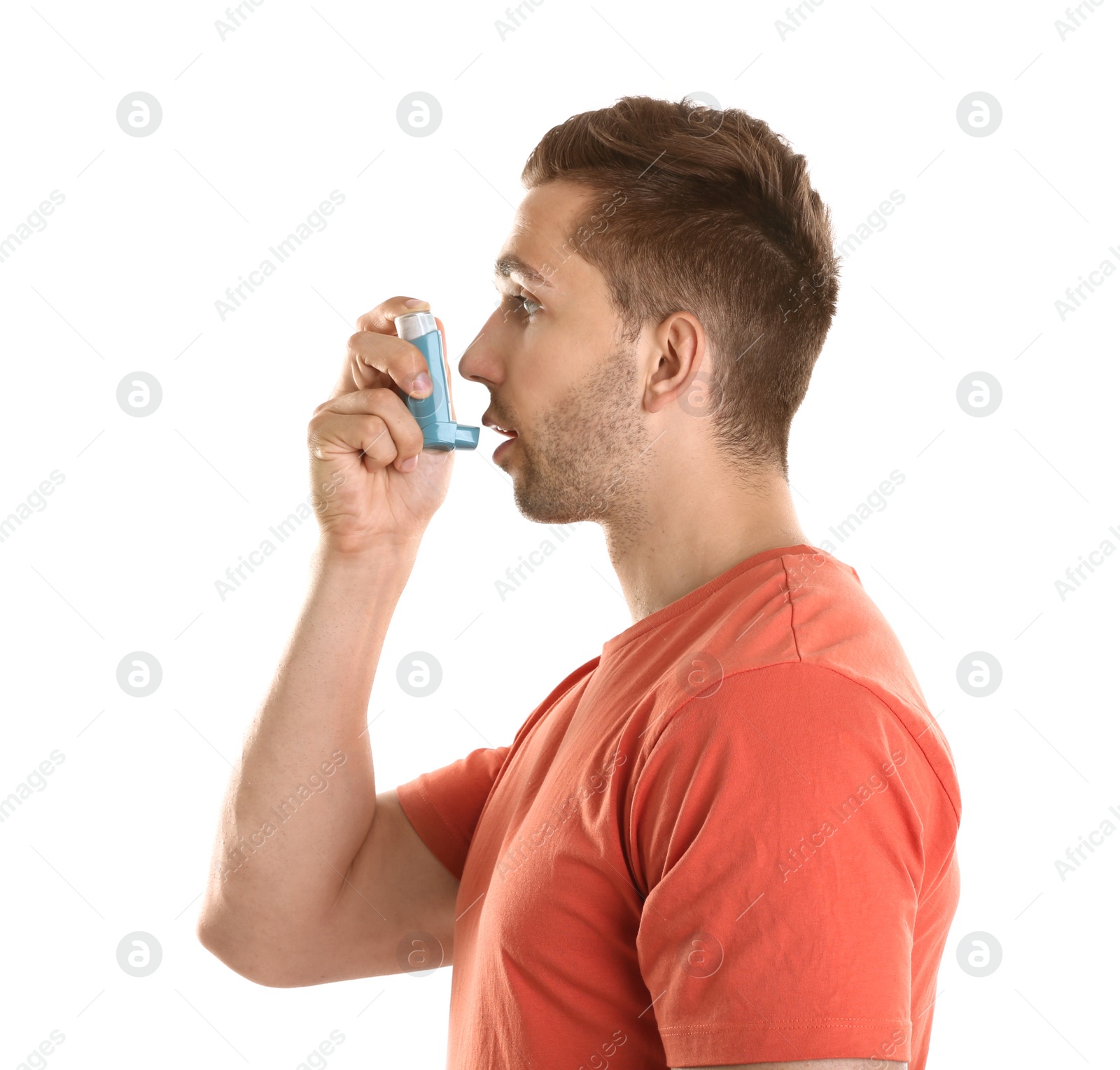 Photo of Young man with asthma using inhaler on white background