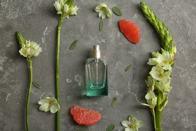 Photo of Beautiful composition with bottle of perfume on grey background, flat lay