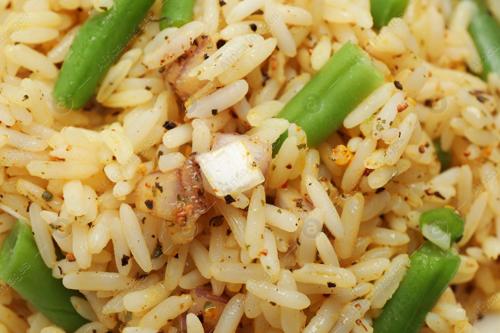 Photo of Tasty rice pilaf with vegetables as background, closeup