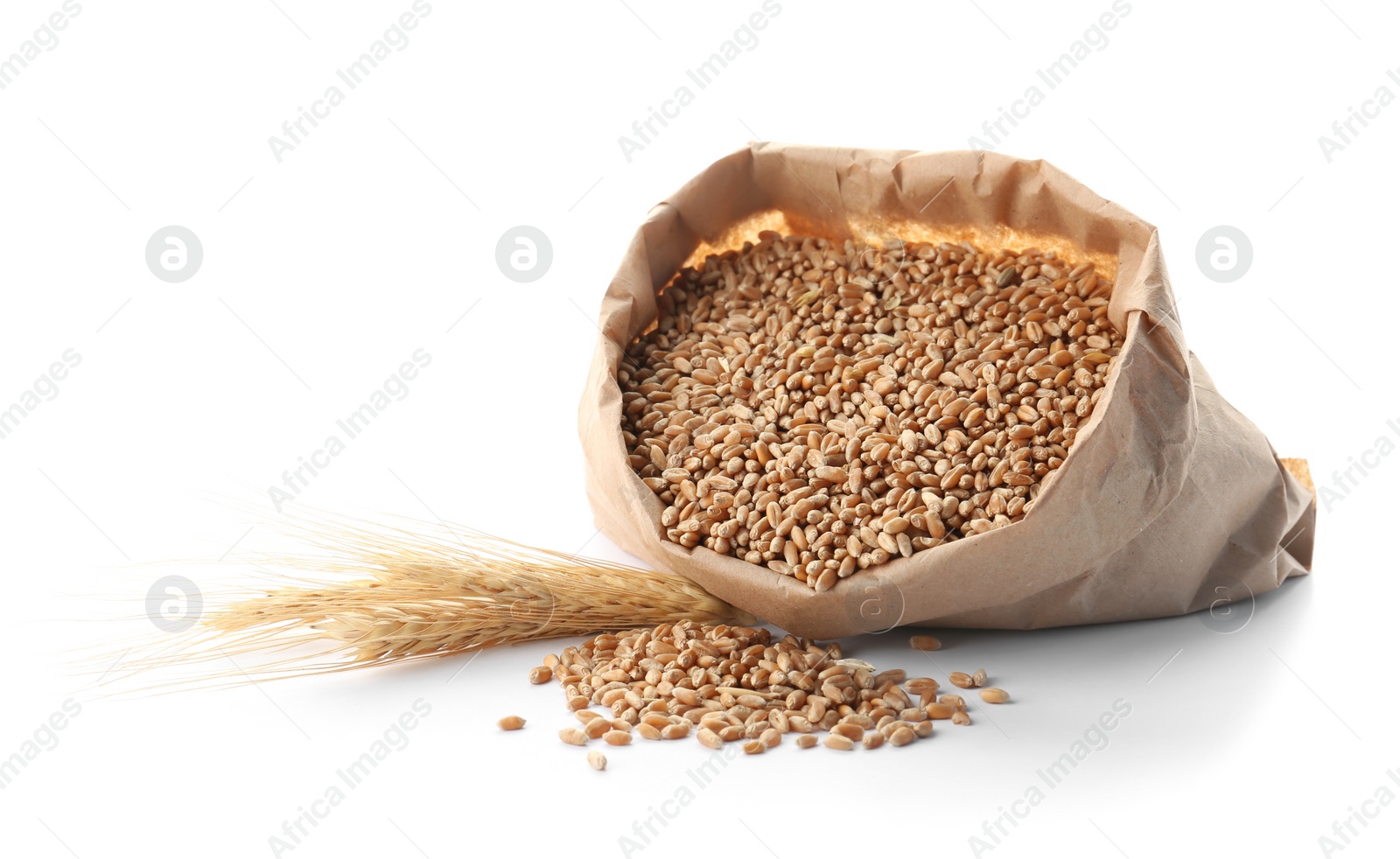 Photo of Paper bag with wheat grains and spikelets on white background