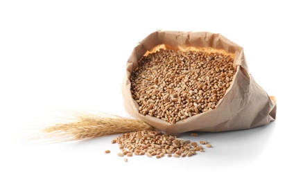 Paper bag with wheat grains and spikelets on white background