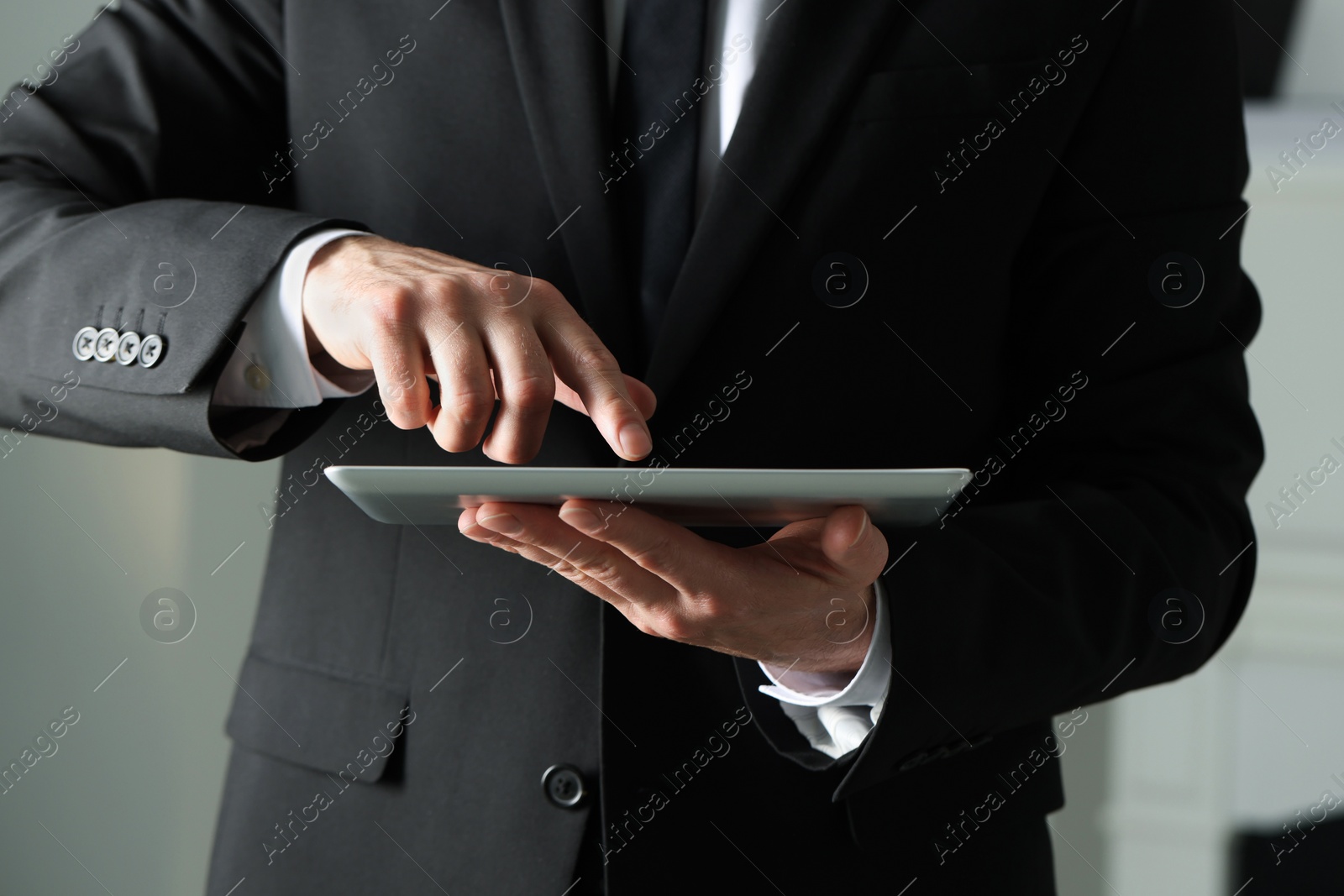 Photo of Closeup view of man using new tablet indoors