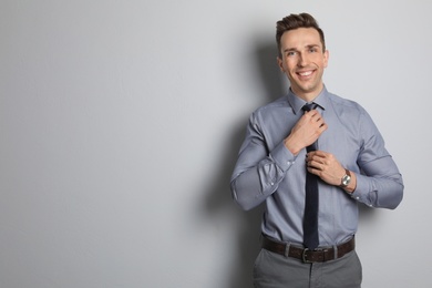 Male real estate agent on grey background