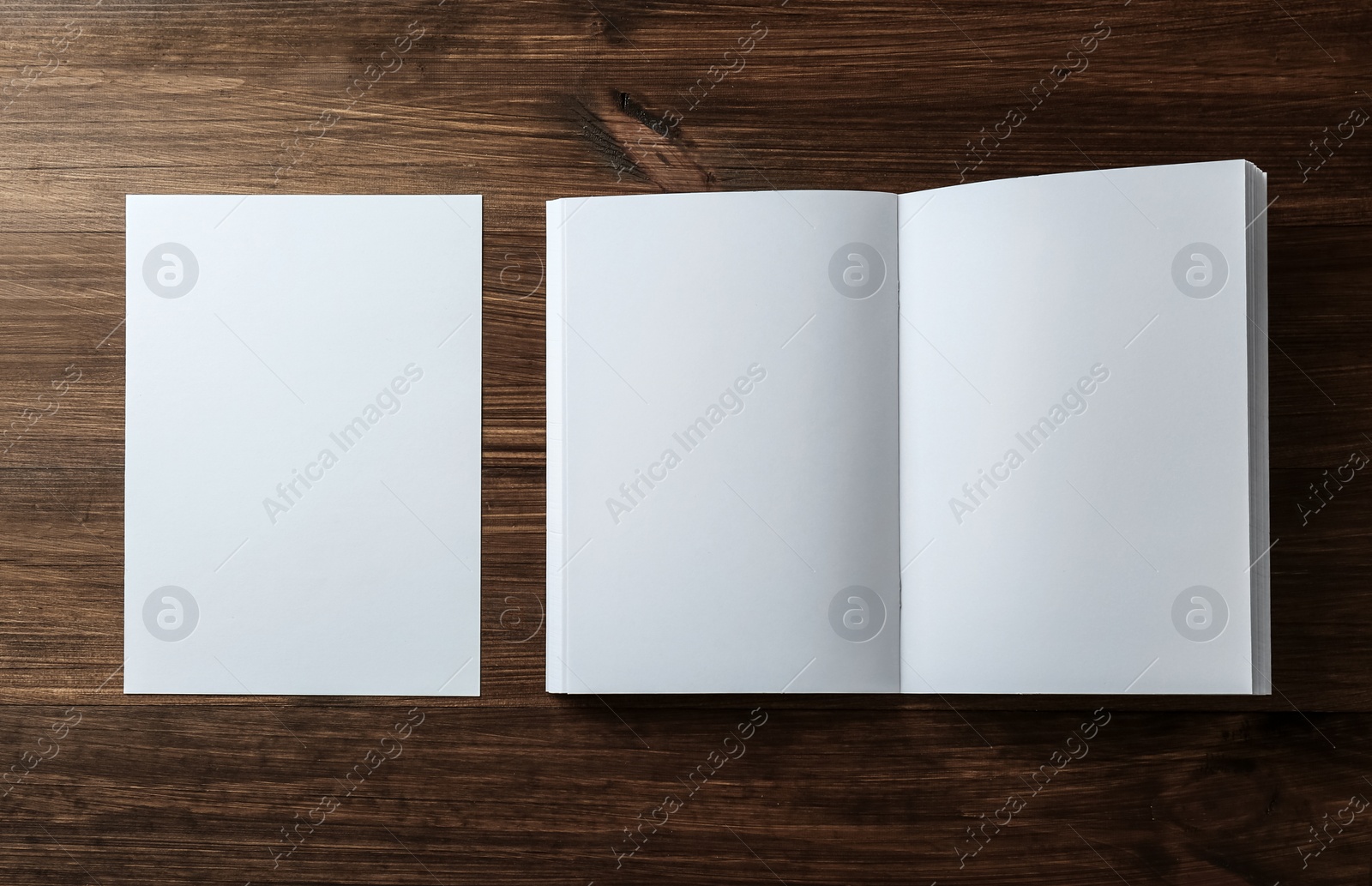 Photo of Sheet of paper and blank brochure on wooden table, flat lay. Mockup for design