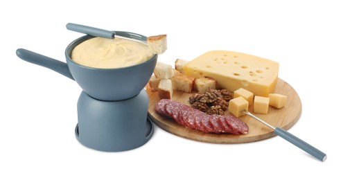 Fondue with tasty melted cheese, forks and different snacks isolated on white