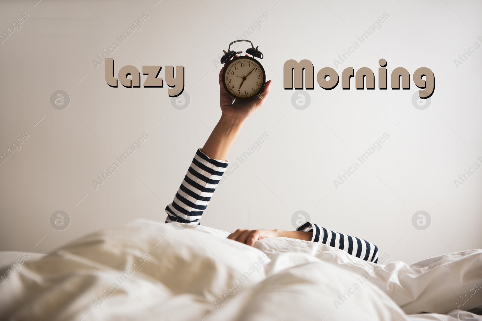 Image of Woman with alarm clock lying in bed, closeup. Lazy morning