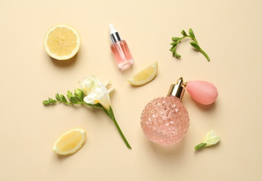 Photo of Flat lay composition with elegant perfume on beige background