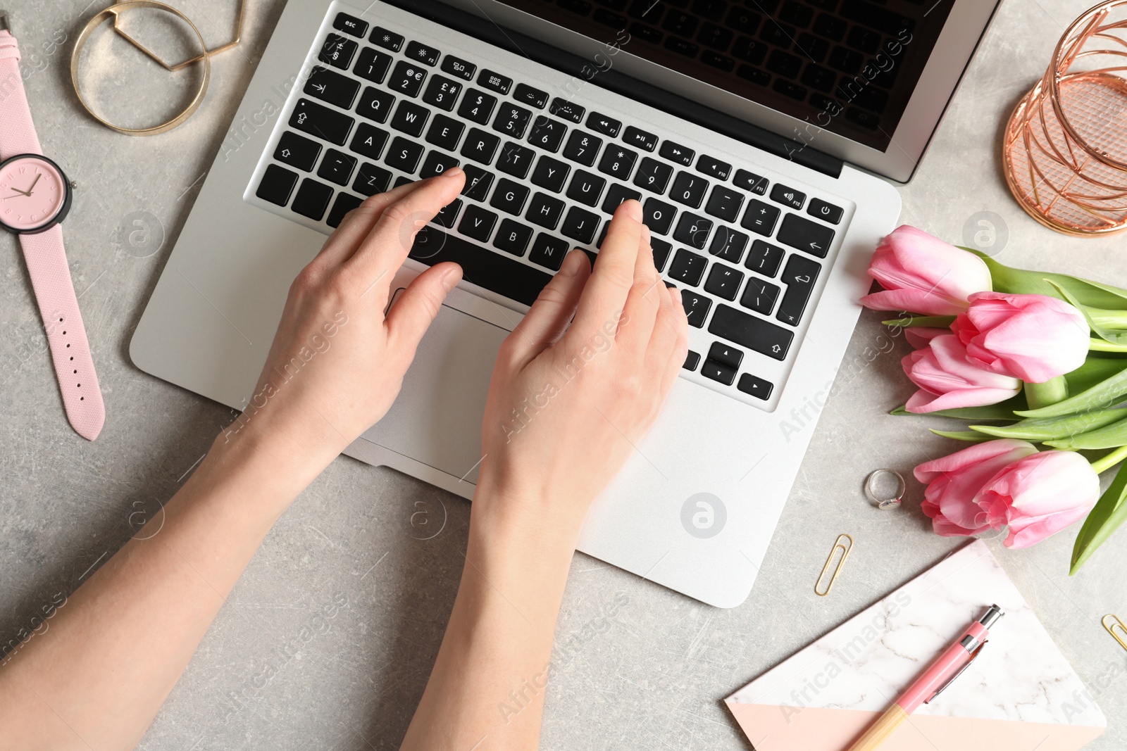 Photo of Woman working with laptop at table, top view