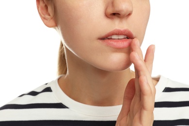 Photo of Woman with herpes applying cream onto lip against white background, closeup