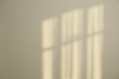 Light and shadows from window on wall indoors