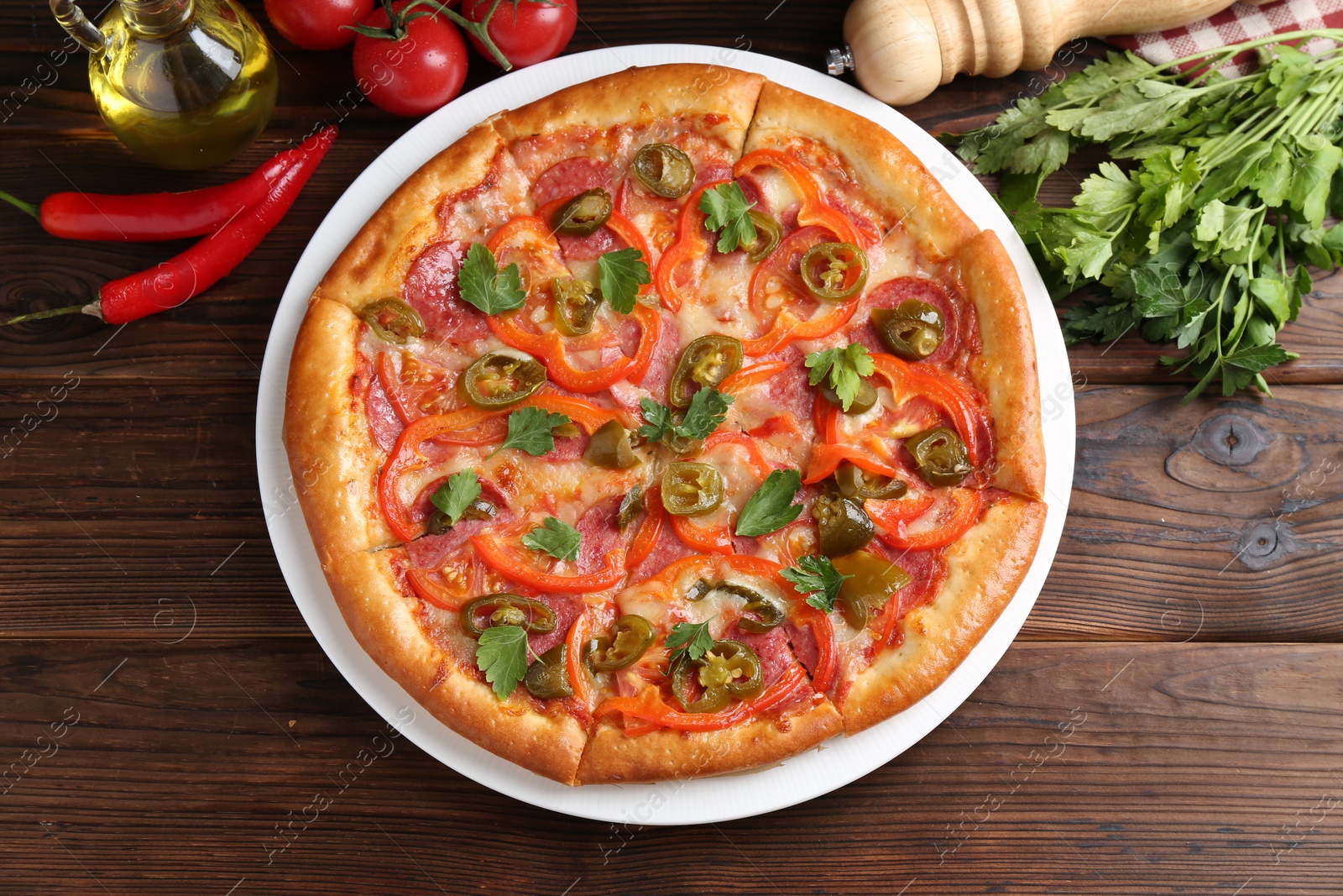 Photo of Delicious pizza Diablo and ingredients on wooden table, flat lay