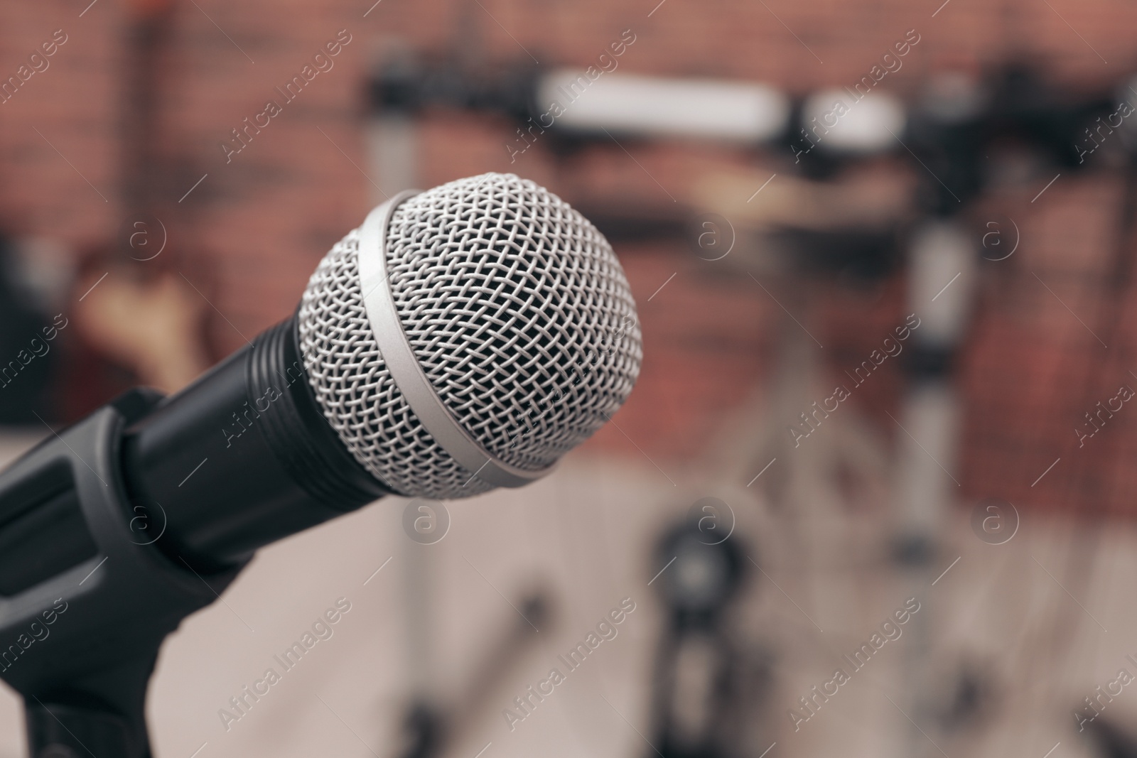 Photo of Modern microphone on blurred background, closeup. Space for text