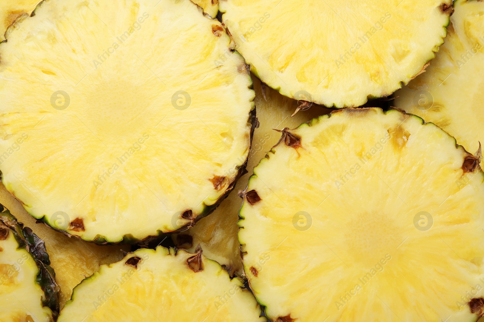 Photo of Slices of tasty ripe pineapple as background, top view