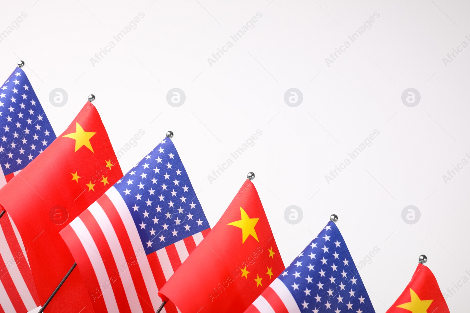 Photo of USA and China flags on white background. International relations