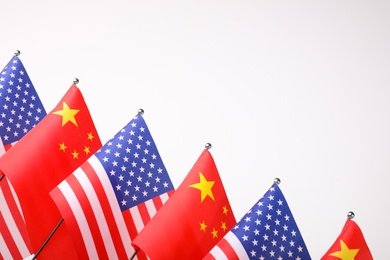 Photo of USA and China flags on white background. International relations