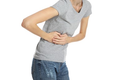 Photo of Young woman suffering from liver pain on white background, closeup