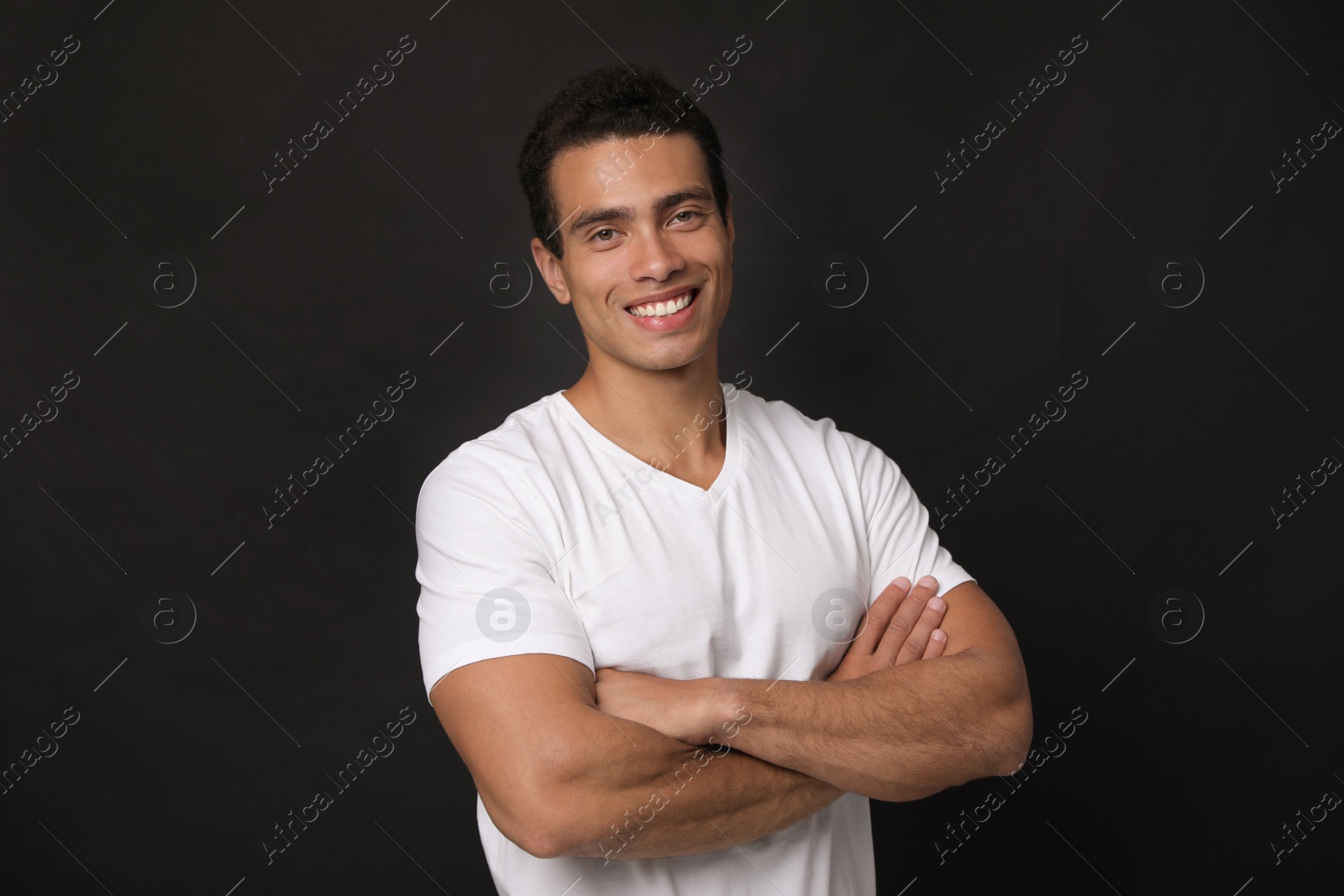 Photo of Handsome young African-American man on black background