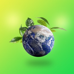 Image of Recycling concept. Earth planet with green leaves on color background