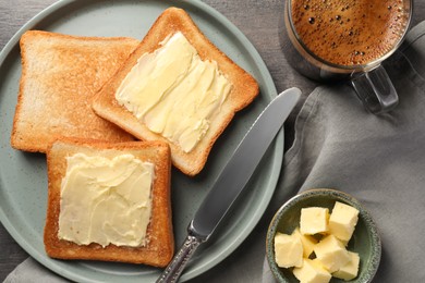 Photo of Delicious toasts served with butter and coffee on grey wooden table, flat lay