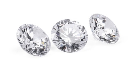 Photo of Three beautiful shiny diamonds isolated on white