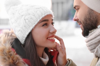 Photo of Happy young couple spending time together at winter fair. Christmas celebration