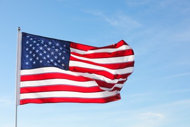 Photo of American flag fluttering outdoors on sunny day