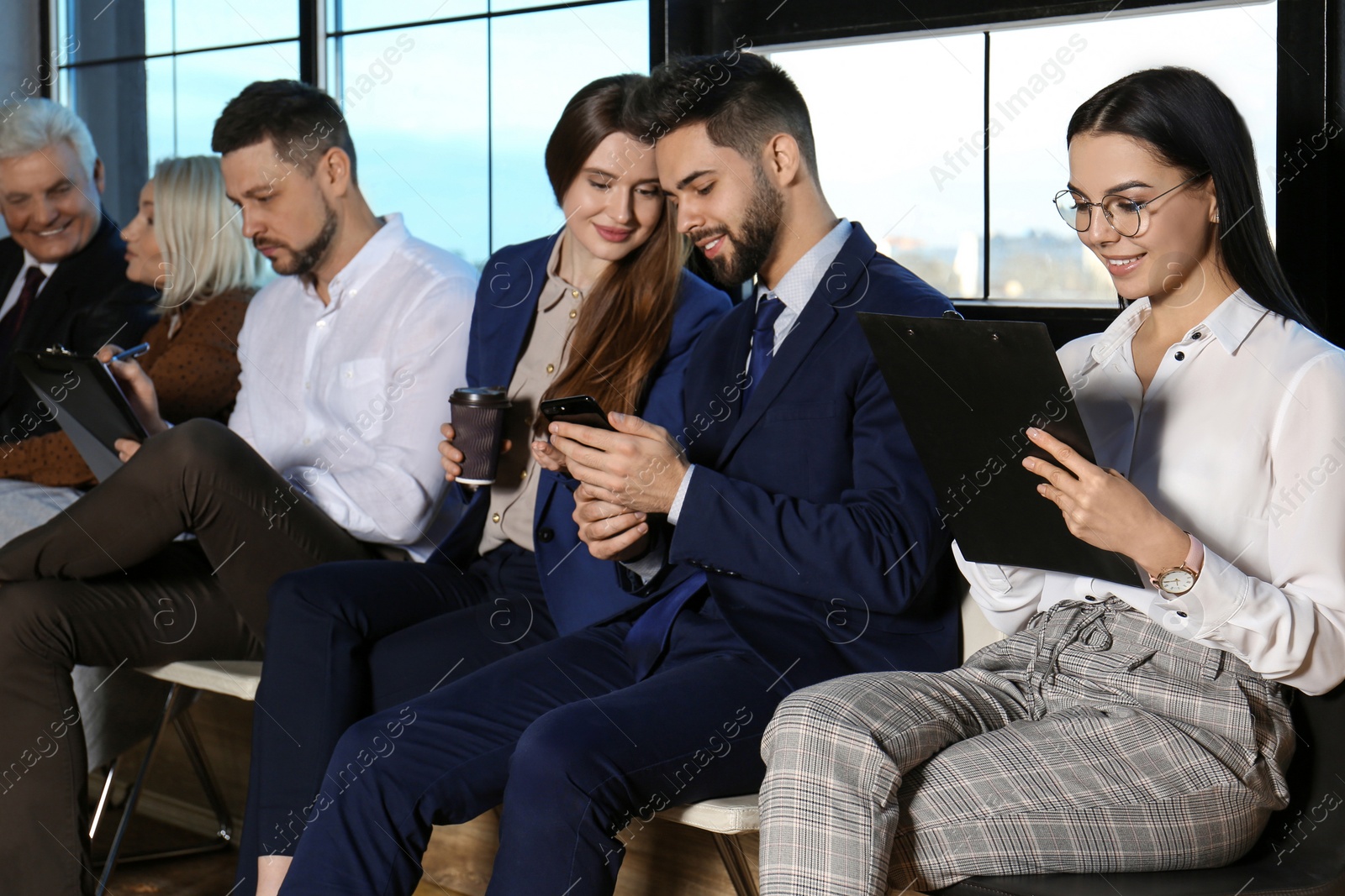 Photo of People waiting for job interview in office hall