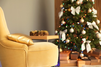 Photo of Room interior with beautiful Christmas tree and gifts