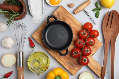 Photo of Composition with cooking utensils and fresh ingredients on white background, top view