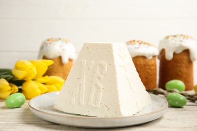Photo of Traditional cottage cheese Easter paskha on white wooden table