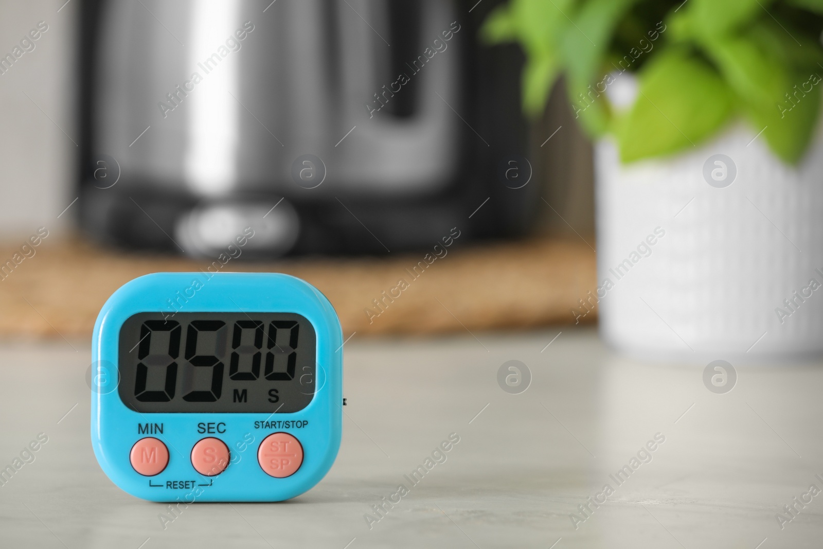 Photo of Digital kitchen timer on white table indoors. Space for text