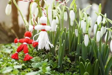 Photo of Traditional martisor and beautiful snowdrops outdoors. Symbol of first spring day