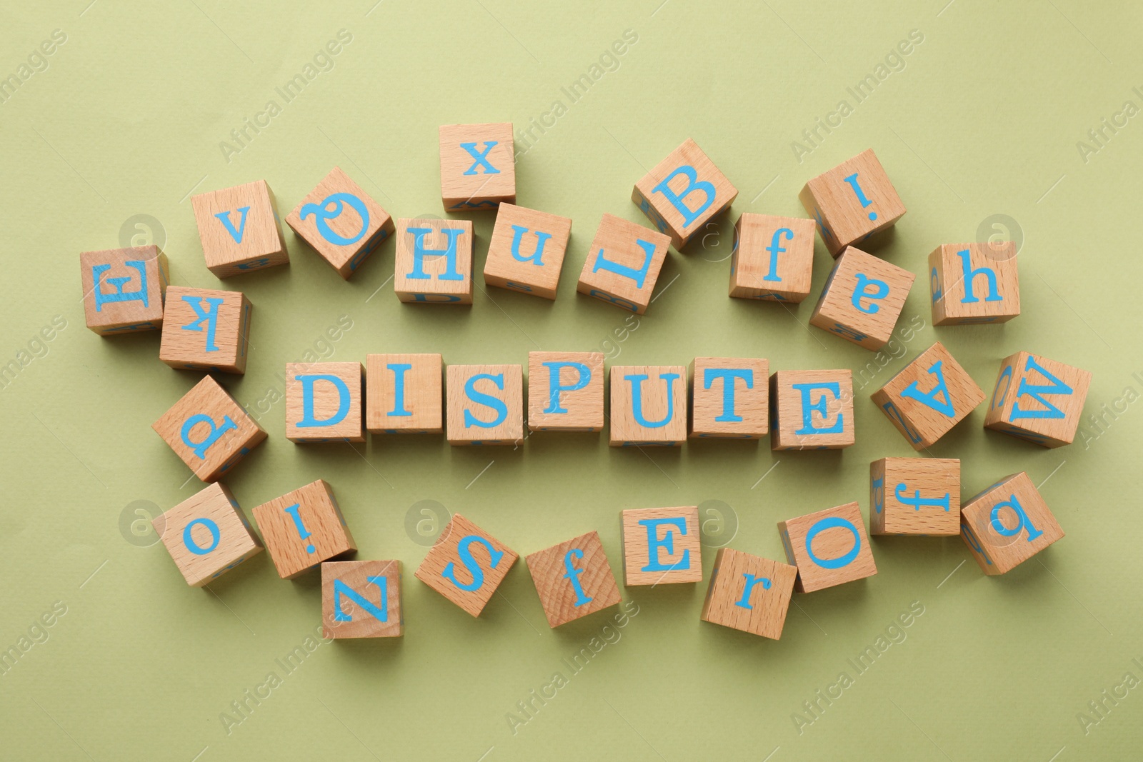 Photo of Cubes with word Dispute on light green background, flat lay