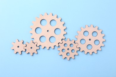 Photo of Business process organization and optimization. Scheme with wooden figures on light blue background, top view