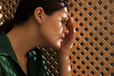 Photo of Upset woman listening to priest during confession in booth