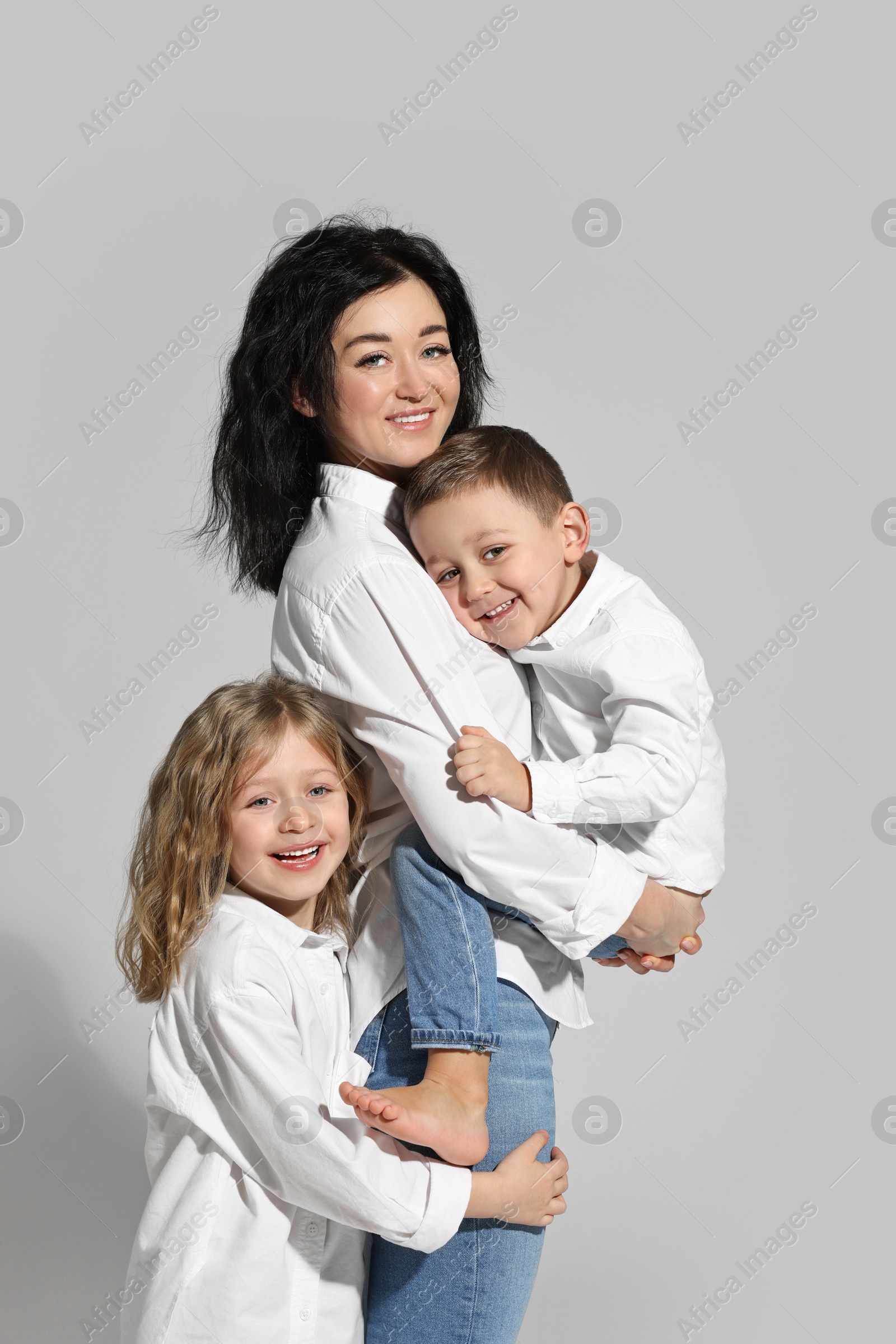 Photo of Little children with their mother on white background