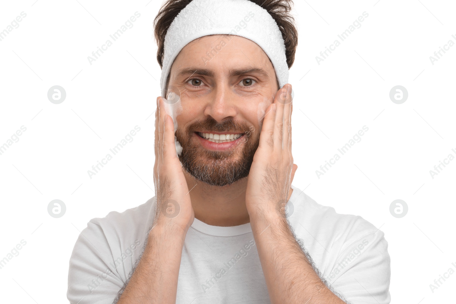 Photo of Man with headband washing his face on white background