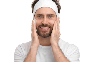 Man with headband washing his face on white background