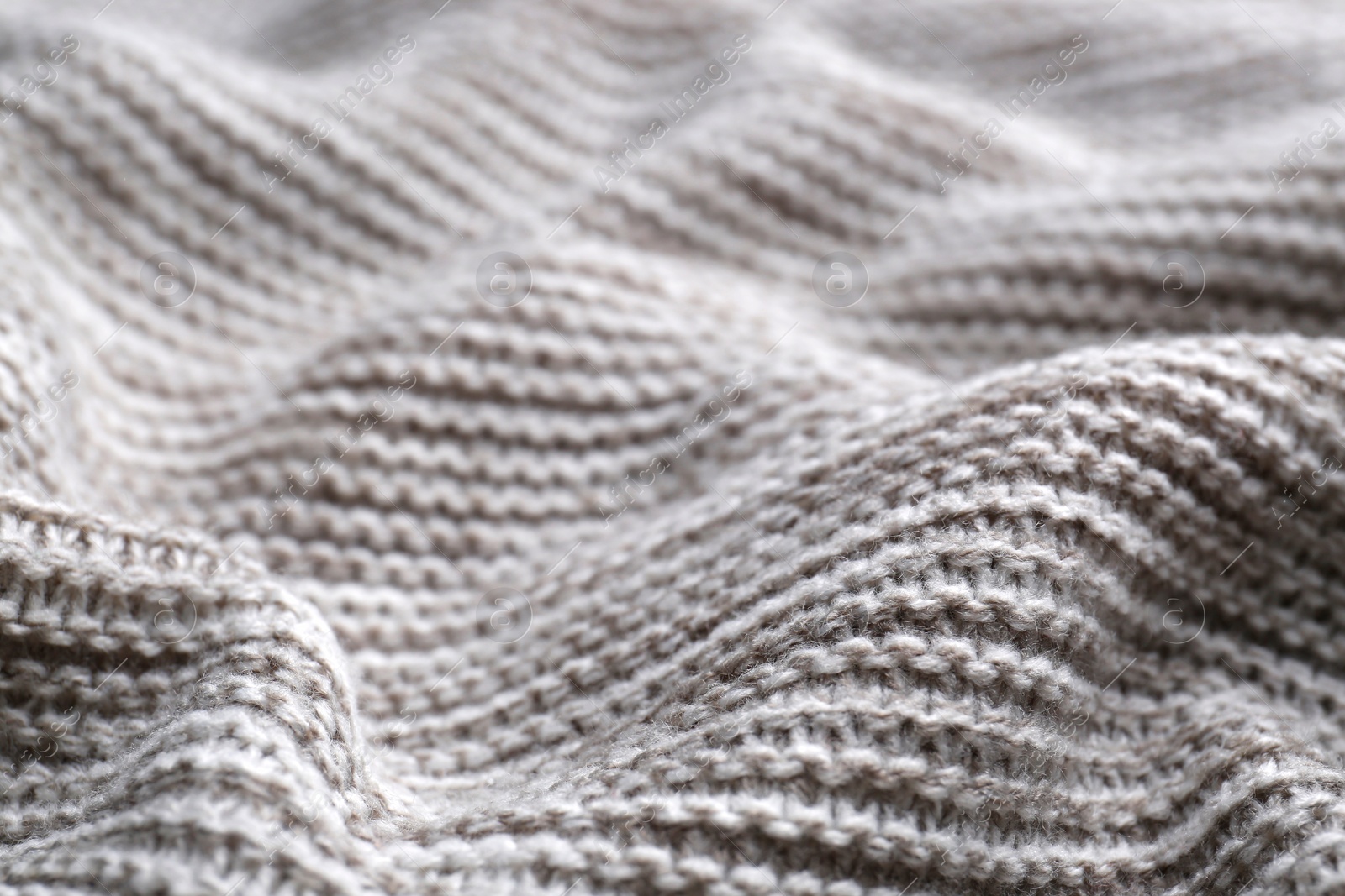 Photo of Beautiful grey knitted fabric as background, closeup