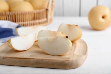 Slices of apple pear on white wooden table