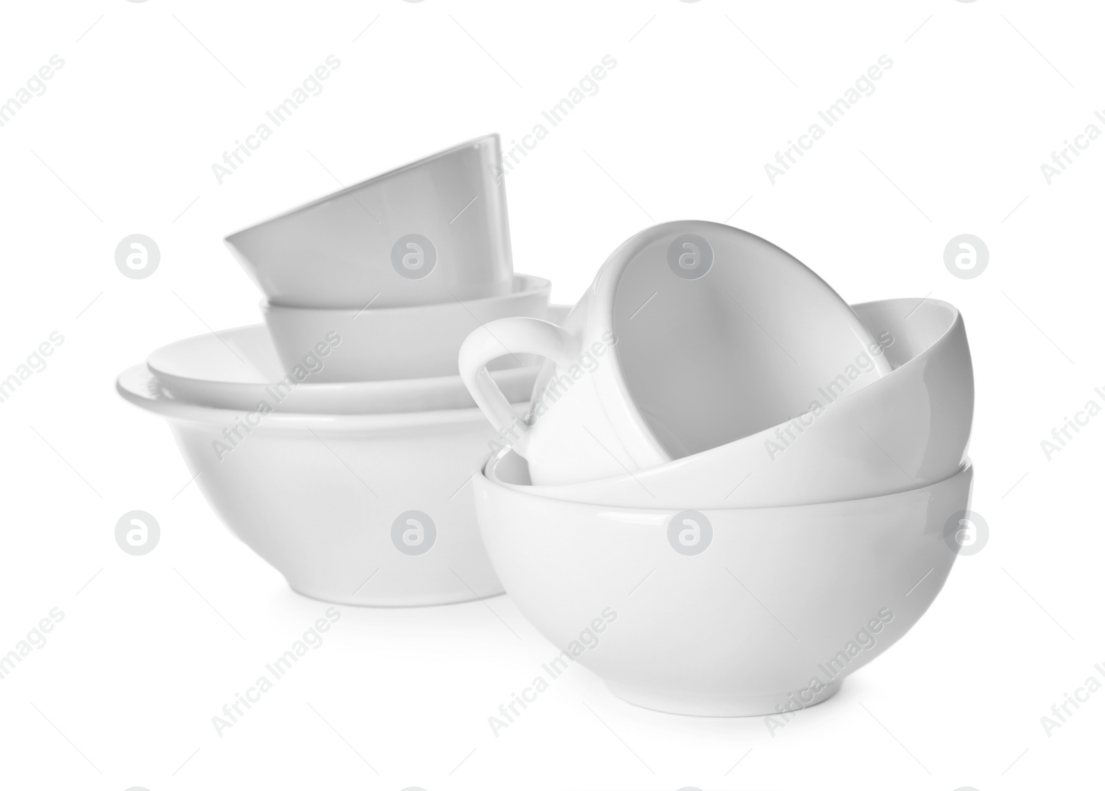 Photo of Clean bowls and cups on white background