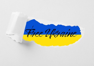 Illustration of Free Ukraine. Ukrainian flag with phrase, view through torn white paper