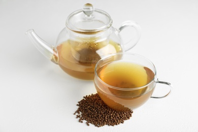 Delicious buckwheat tea and granules on white background